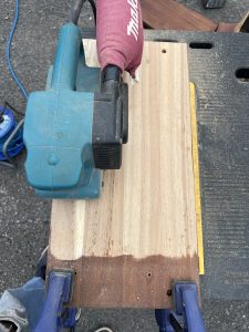 use belt sander with the grain to finish surface smooth